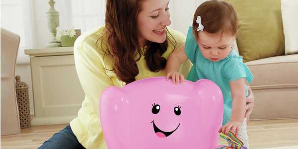 A mother playing with her baby with a pink laugh and learn smart stages chair.